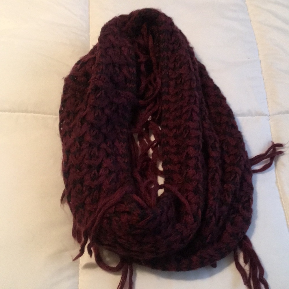 Burgundy and black knitted infinity scarf with fringes.